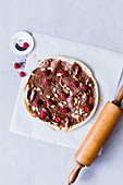 Chocolate pizza with raspberries and almond flakes