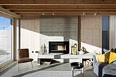Sunlight in modern living room with concrete fireplace
