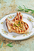 Grilled pork chop with pistachios and rosemary