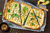 Zucchini goat's cheese tart with pine nuts