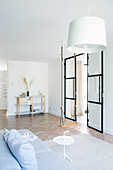Swing and glass-and-steel door in minimalist living room