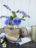 Spring arrangement of blue violas and peppermint flowers