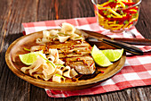Grilled marinated tuna fish with tagliatelle and lime