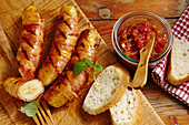 Grilled bananas wrapped in bacon with a tomato and chilli jam and white bread
