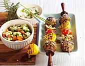 Grilled minced meat kebabs with millet salad and sour cream
