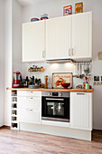 White fitted kitchen with oven