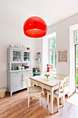 Dining area with white-painted wooden table and dresser