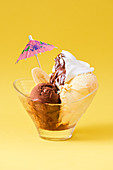Banana-split vanilla and chocolate ice cream with cream and hot chocolate
