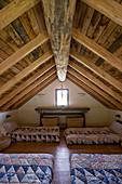 Bedroom with wood-beamed ceiling