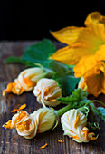 Fresh courgette flowers on a wooden table