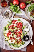 Caprese with grilled courgette, dried tomatoes and capers