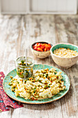 Baked cauliflower with olives salsa and couscous