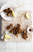 Grilled beef skewers with chilli flakes and lemon