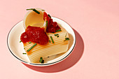 Cooked cannelloni with tomato sauce and herbs