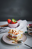 A slice of strawberry and rhubarb cake with meringue