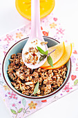 Roasted muesli with amaranth, sesame seeds, sunflower seeds and honey served with fruit and yoghurt