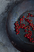 An antique collander with red currants