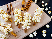 Large pretzel sticks with white chocolate and popcorn