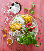 A lunch bowl with lentils, coconut, fragrant rice and radishes