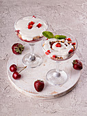 Summer cake in glass, strawberry sweet cherry layered trifle with biscuit, mascarpone and whipped cream