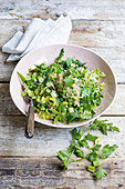 Green quinoa salad with mange tout and peas