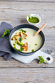 White root vegetable cream soup with parsley oil