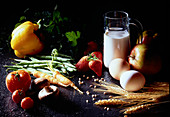 Still life with milk, eggs, fruits, vegetables, mushrooms and ears of corn