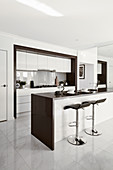 Island counter with bar stools in elegant interior