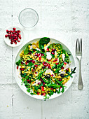 Speedy turkey couscous with arugula and pomegranate seeds