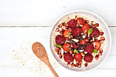 Porridge with red berries and pomegranate seeds