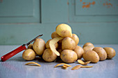 Potatoes and a peeler