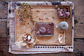 Dried garlic flowers, chive flowers, candle and garlic bulb decorating table