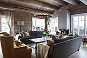 Open fireplace in living room of modern log cabin