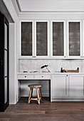 Stool at built-in workstation in classic fitted kitchen