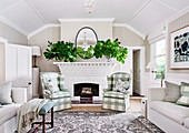 Cottage style living room with checkered upholstered armchairs in front of a white fireplace
