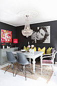 Chandelier and dark grey walls in eclectic dining area