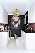 Large portrait on black end wall in white, modern kitchen