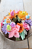 Chick decorations on wreath of colourful paper flowers