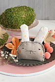 Fabric Easter bunny and moss egg decorating table