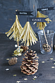 Paper fir trees with pennants on pine cones as name cards