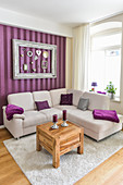 Decorations in picture frame on striped wall above sofa