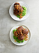 Meat patties with mushy peas and fried onions