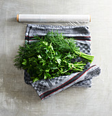 Herbs wrapped in a damp tea towel and cling film