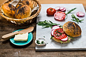 Homemade poppy seed rolls with radish and tomatoes