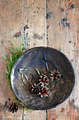 Christmas-tree decorations made from pine cones in bowl