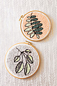 Punch needle leaf motifs in two embroidery frames