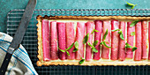 A rhubarb tart with mint leaves