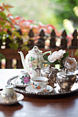 China tea set, silver milk jug and sugar bowl on silver tray