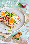 Whole-grain sandwich with fried radish, boiled egg, herbs and pepper