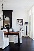 Rustic wooden table with coveres chairs in front of the fireplace in the dining room